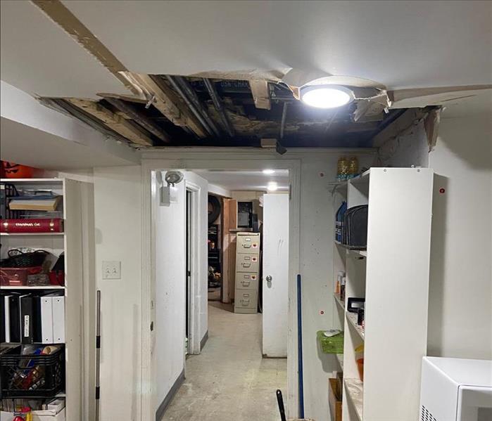 Basement with tile floor and damaged ceiling 