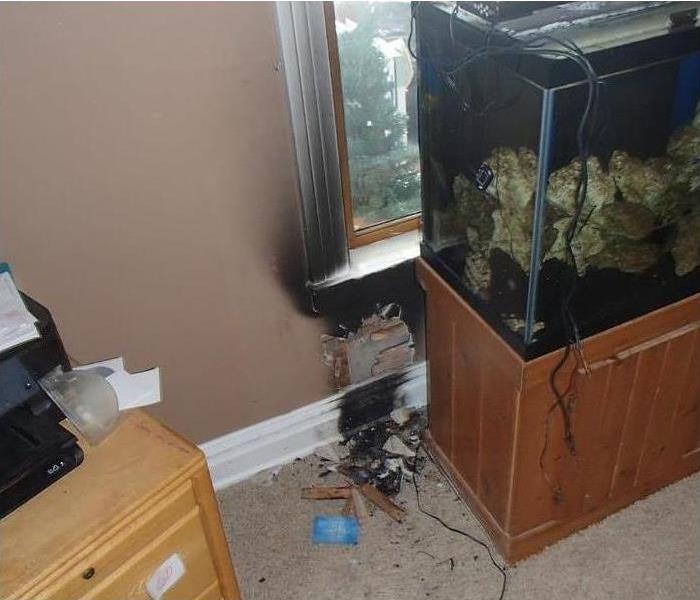 Fire damage to a wall with a fish tank 