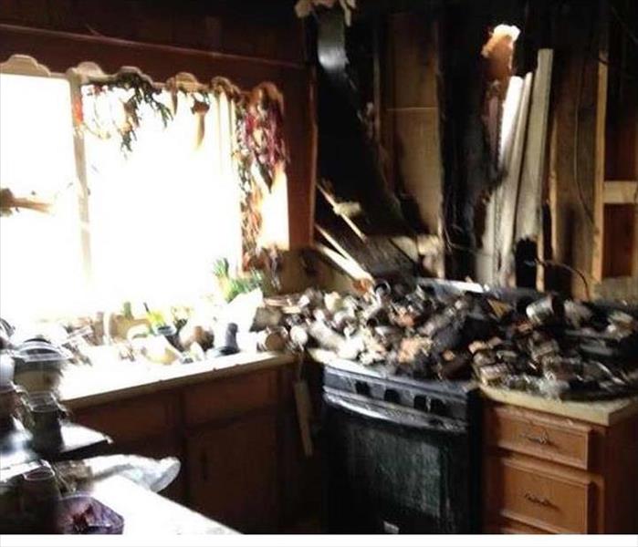 Fire damage in a kitchen, ceiling has fallen through 