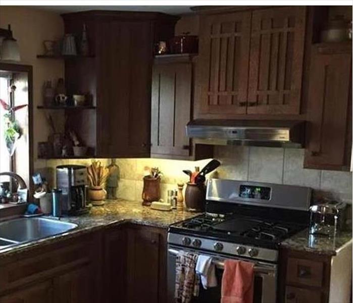 A kitchen with brown wood cabinets. 