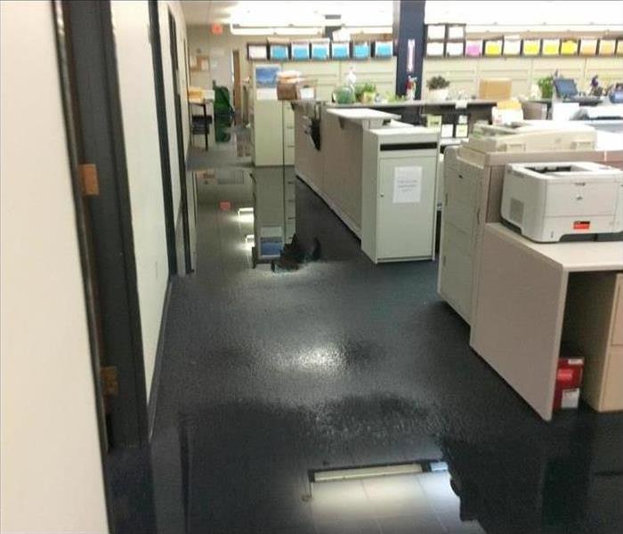 Standing water in a office with blue carpet