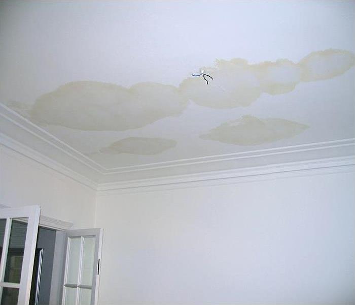 brown water spots on a white ceiling