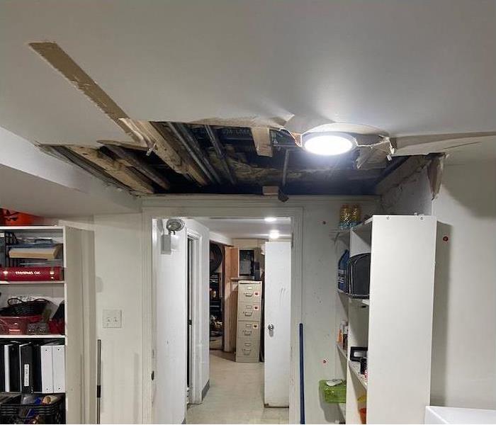 Ceiling with water damaged areas of drywall removed